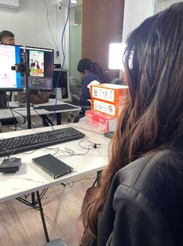 Production team monitors the broadcast from behind the camera